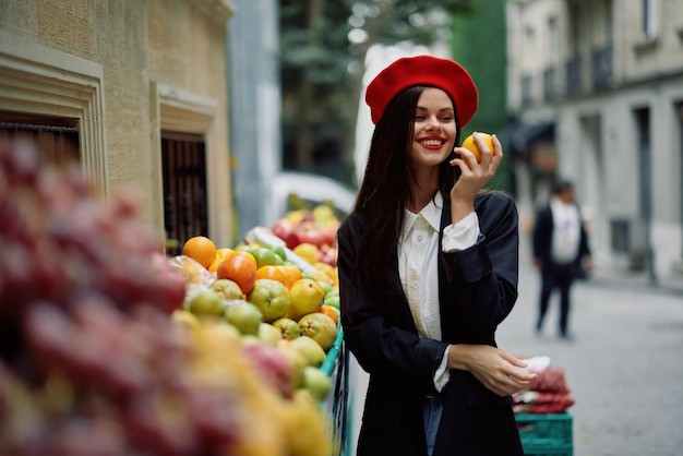 Woman smile with teeth tourist walks in the city market with fruits and vegetables choose goods stylish fashionable clothes and makeup spring walk travel