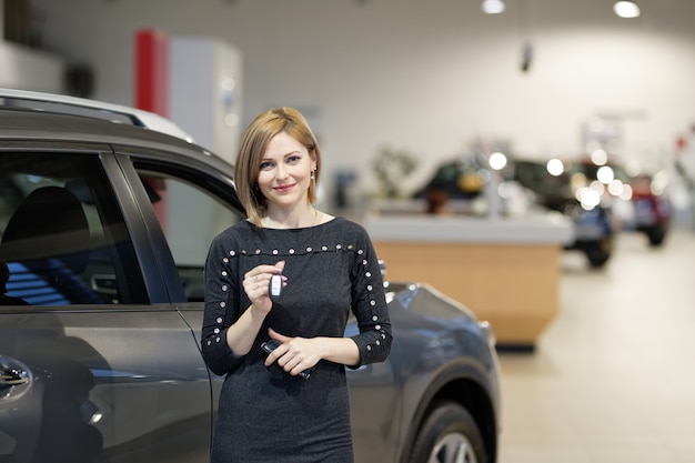 Woman smiles in the background of dealership