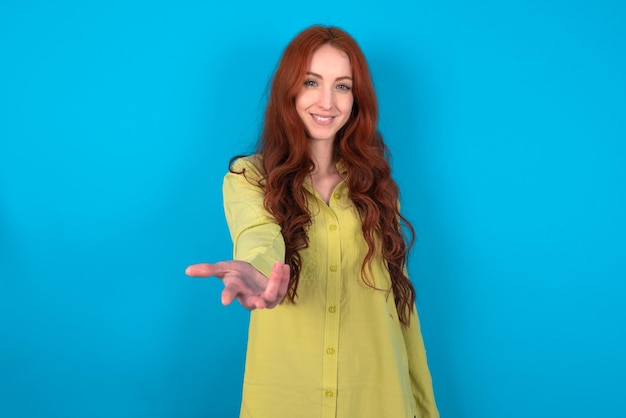 woman smiling cheerful offering palm hand giving assistance and acceptance