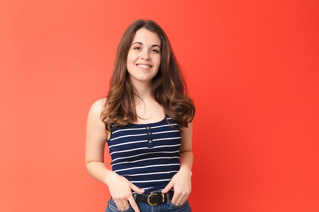 Woman smiling cheerfully and casually with a positive, happy, confident and relaxed expression