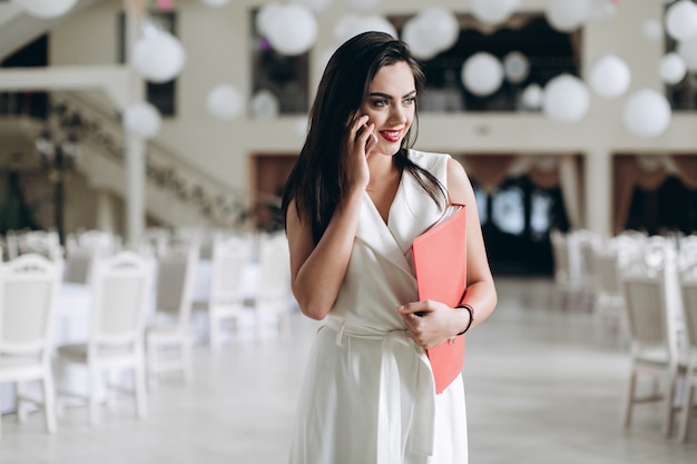 Woman smiling and conversating with phone in restaurant