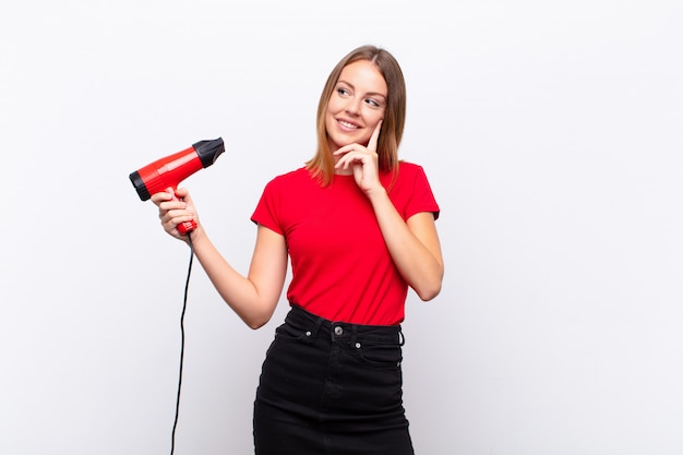 woman smiling happily and daydreaming or doubting, looking to the side