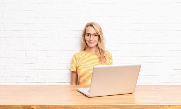 woman smiling positively and confidently, looking satisfied, friendly and happy