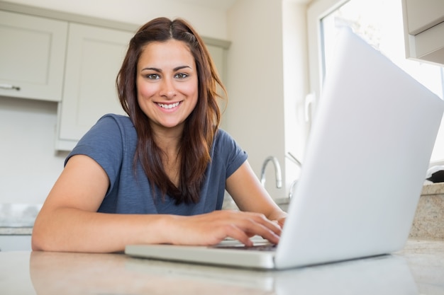 Woman smiling and using laptop