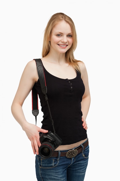 Woman smiling while carrying a camera