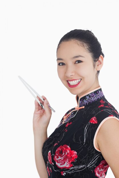 Woman smiling with chopsticks