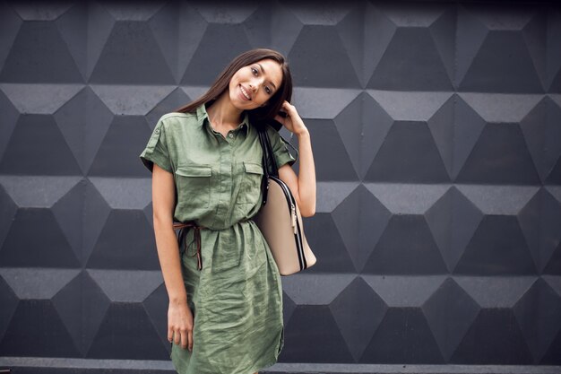 Woman smiling with a shoulder bag