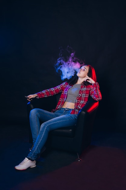 Woman smoking electronic cigarette with smoke