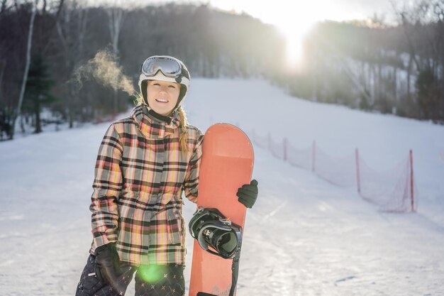 Woman snowboarder on a sunny winter day at a ski resort