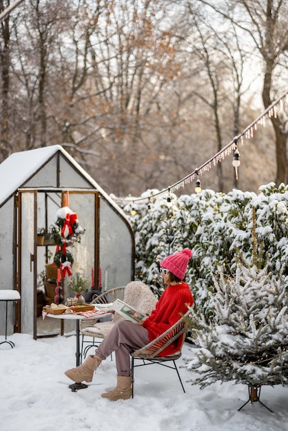 Woman at snowy backyard on winter holidays