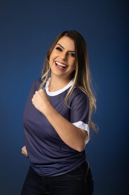 Woman soccer fan cheering for her favorite club and team world cup blue background