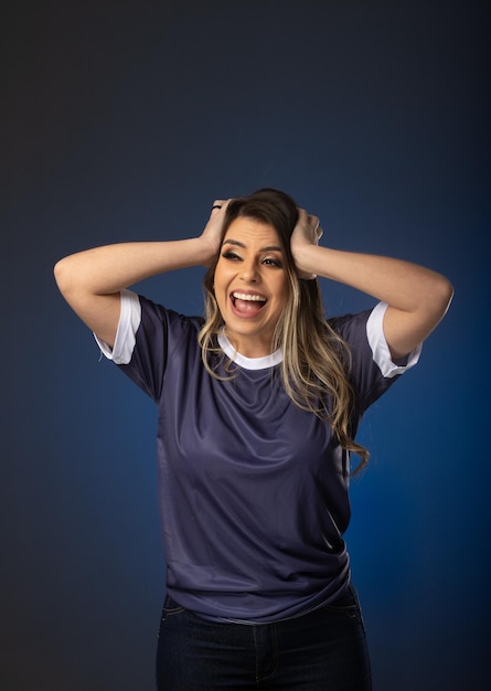 Woman soccer fan cheering for her favorite club and team world cup blue background