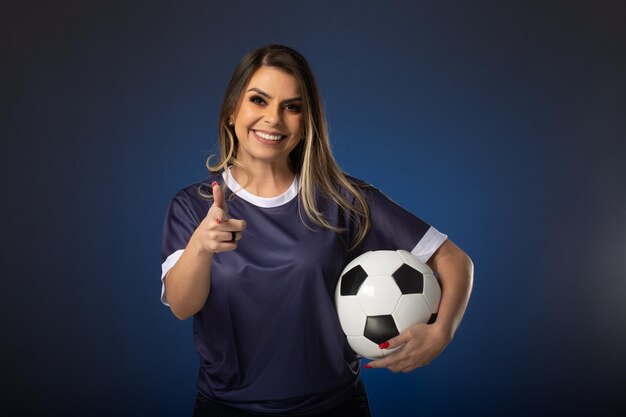 Woman soccer fan cheering for her favorite club and team world cup blue background