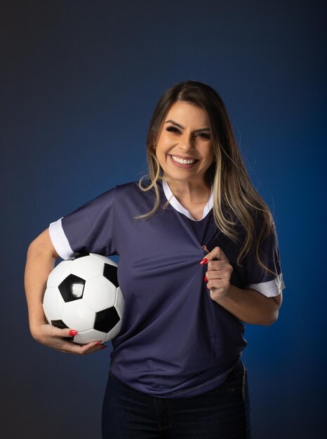 Woman soccer fan cheering for her favorite club and team world cup blue background