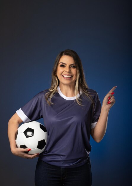 Woman soccer fan cheering for her favorite club and team world cup blue background