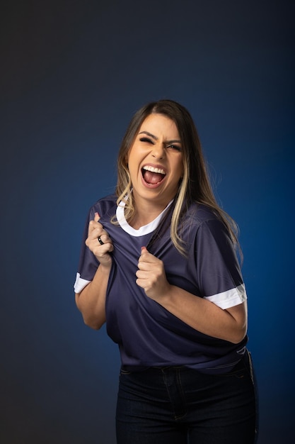 Woman soccer fan cheering for her favorite club and team world cup blue background