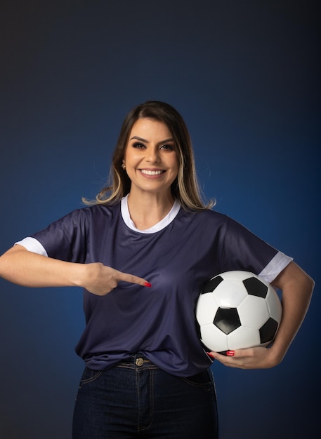 Woman soccer fan cheering for her favorite club and team world cup blue background