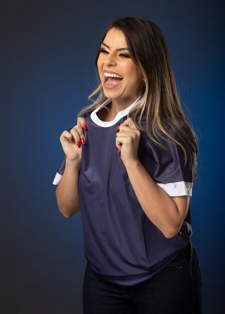 Woman soccer fan cheering for her favorite club and team world cup blue background