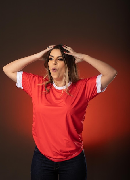 Woman soccer fan cheering for her favorite club and team world cup red background