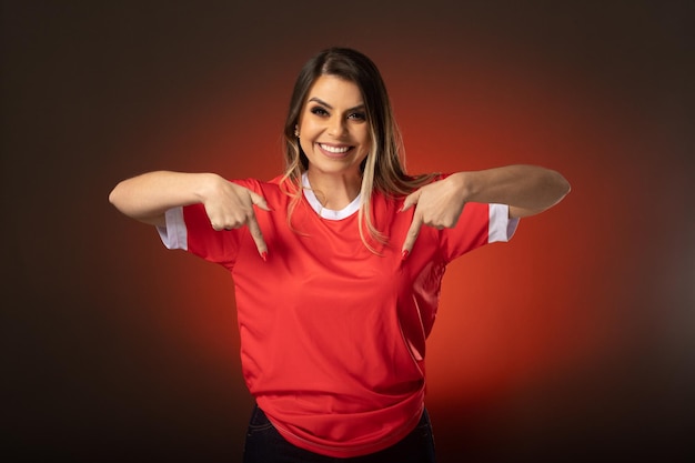 Woman soccer fan cheering for her favorite club and team world cup red background