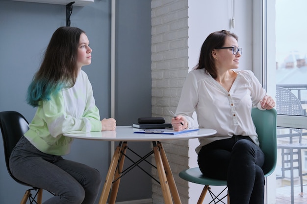 Woman social worker talking to teenage girl