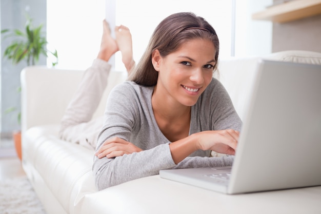 Woman on the sofa reading email