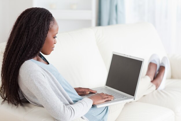 Woman on sofa surfing the internet