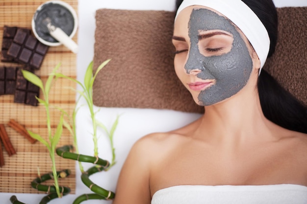 Woman in spa with mask on face