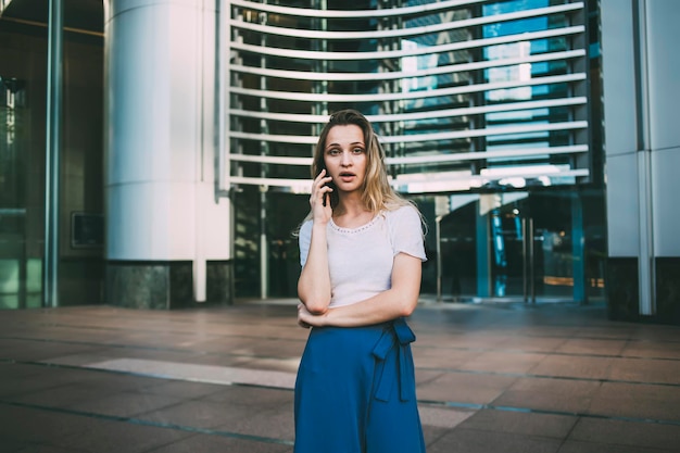 Woman speaking on smartphone in city