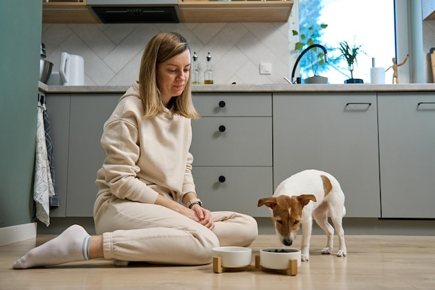 Woman spending time together with her dog at home