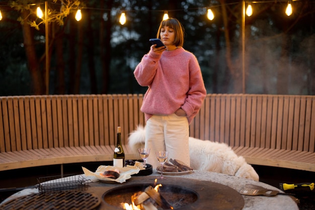 Woman spends leisure time with her dog at lounge outdoor area