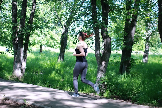 屋外の公園で走る女性スポーツ