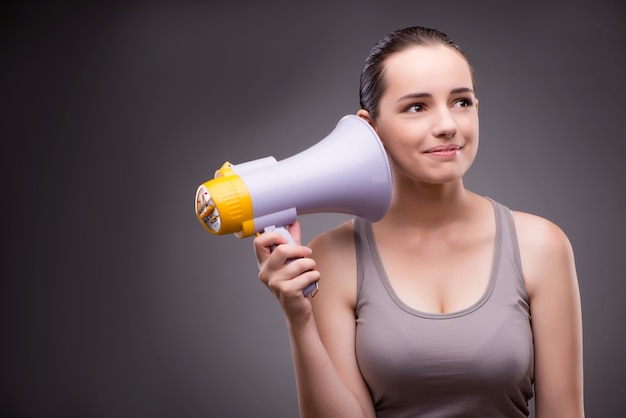 Woman in sports concept with loudspeaker