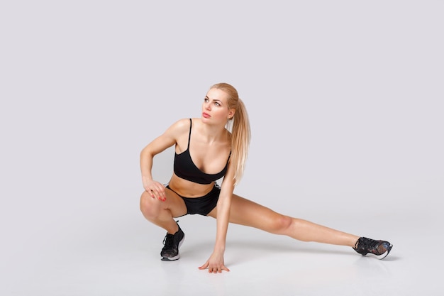 Woman in sportswear does exercises