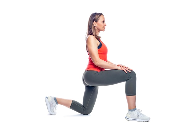 A woman in sportswear is doing exercises Health energy and a beautiful body Isolated on white background