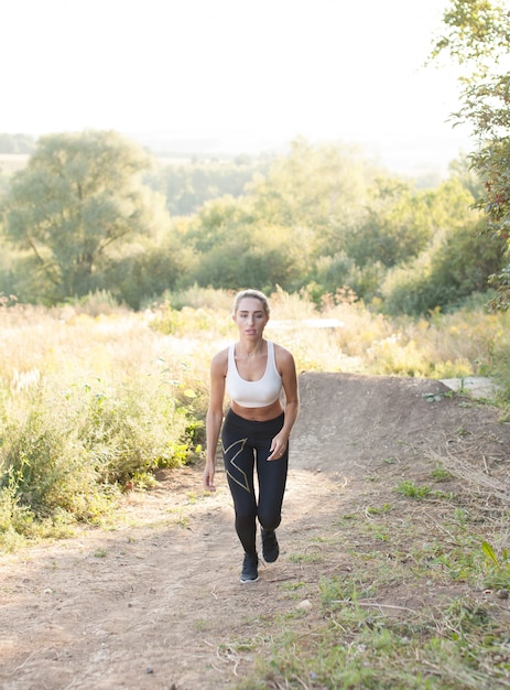 Woman sportswear running on a hill