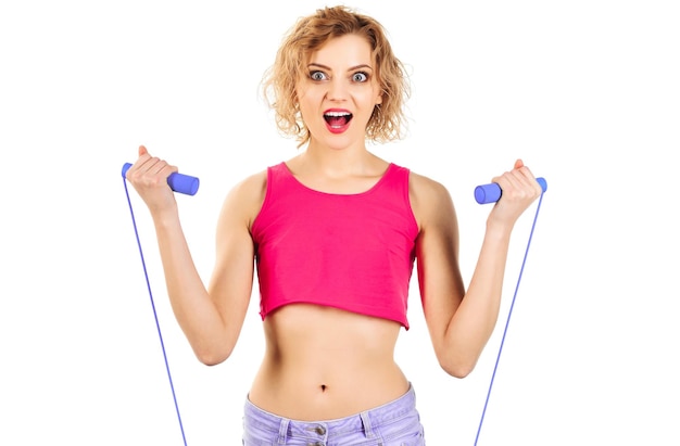 Woman in sportswear with skipping rope excited fitness instructor with jump rope sport lifestyle