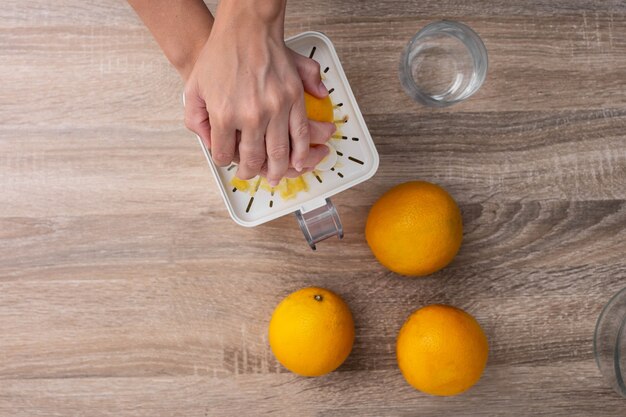 Woman squeezing oranges in the kitchen