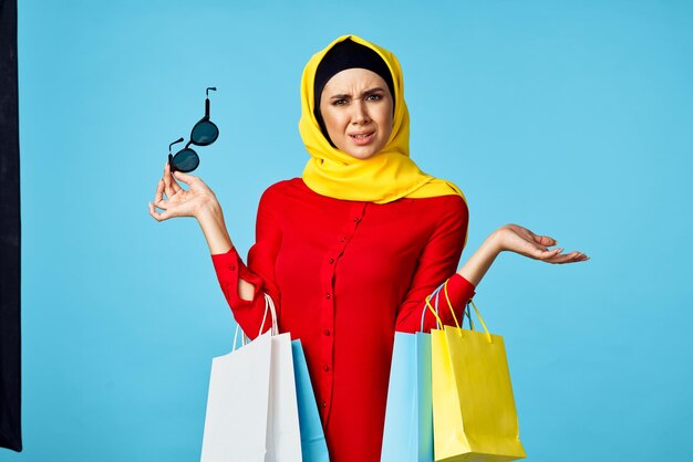 Woman standing against blue background