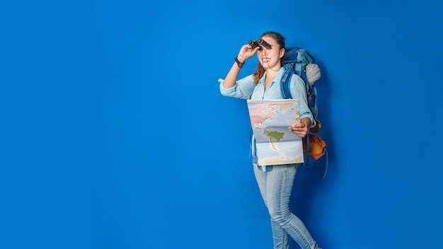 Foto donna in piedi contro il muro blu