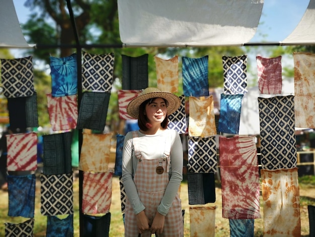 woman standing against fabrics