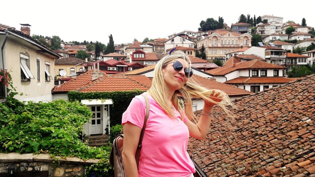 Woman standing against roof tops in town