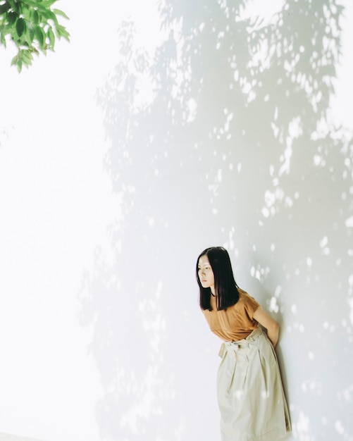 Woman standing against wall