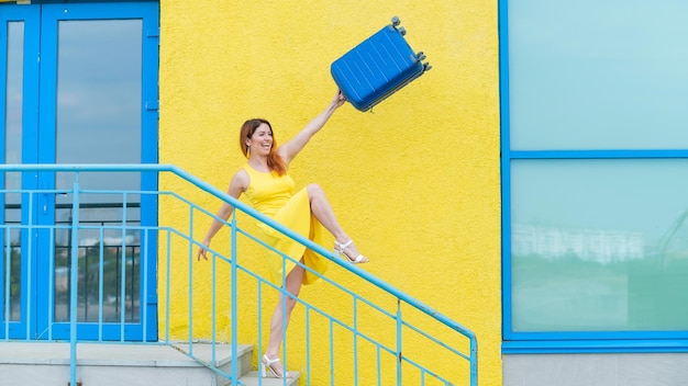 Woman standing against yellow wall