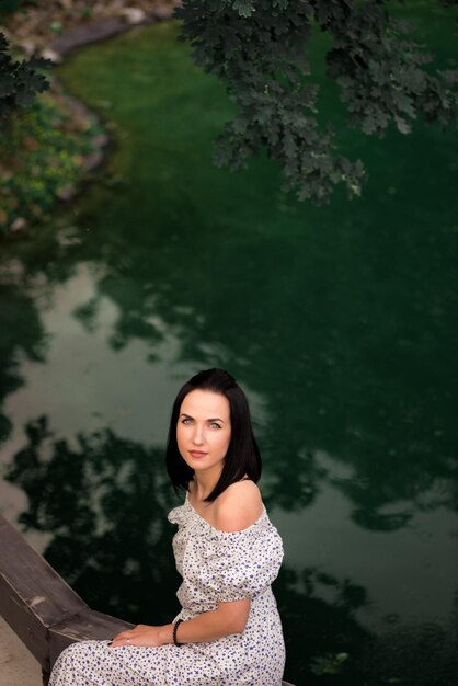 Woman standing on a bridge by the water