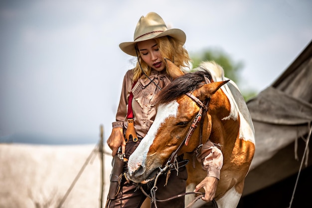 Woman standing by horse