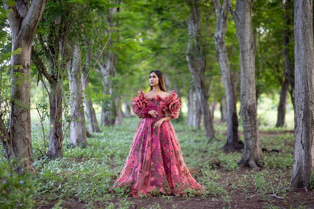 Woman standing by tree in forest