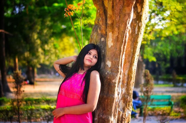 Woman standing by tree at park