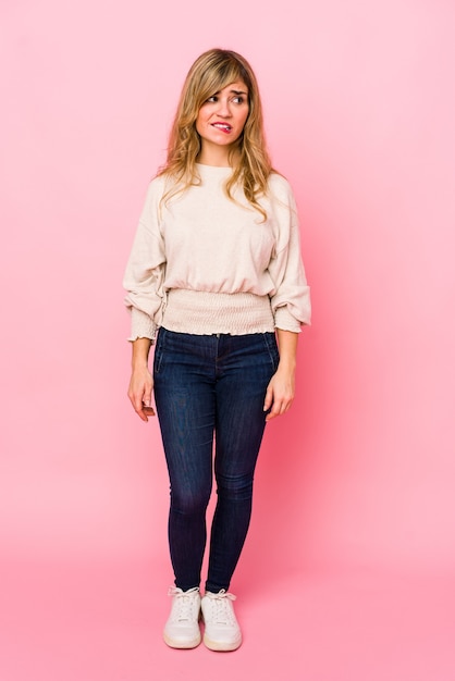 Woman standing confused in studio