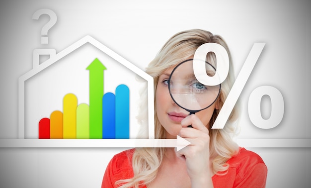 Woman standing behind energy efficient house graphic with question and percentage marks